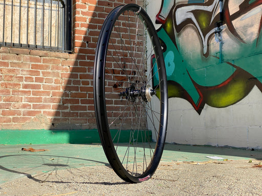 Side view of a profile Elite hub laced to a velocity blunt 35 rim in black