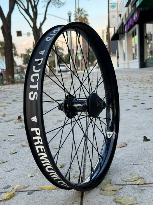 Side view of the Cinema Gsport front hub laced to the Premium Curb cutter rim in black