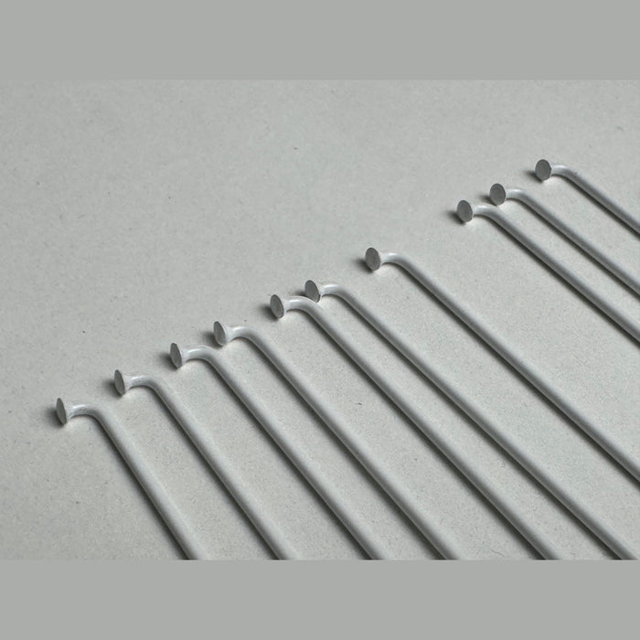 close up of the Stacked Stainless Stainless steel spokes in white, bike wheel spokes