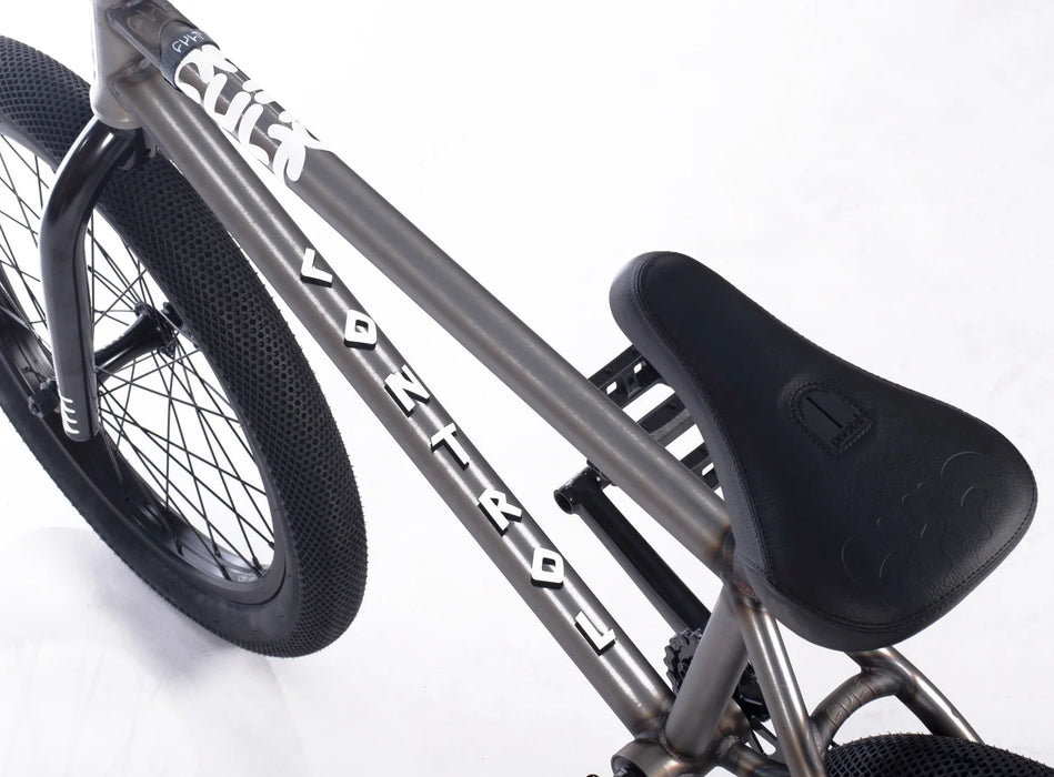 Close up view of the Cult Control bmx bicycle in raw, Cult Control BMX bike with Cult x Vans 2.40 inch tires