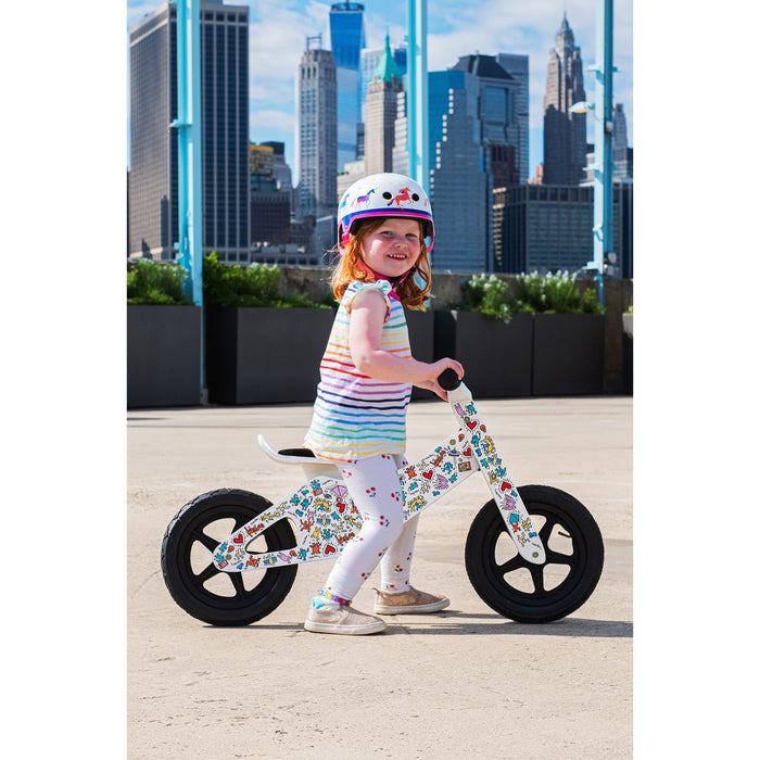 a two year old riding the Affinity Keith haring balance bike