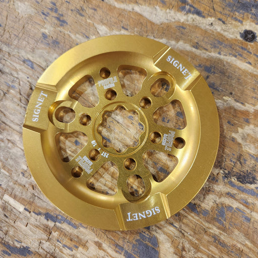 Front view of the Profile Signet guard sprocket in gold