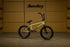 side view of the Sunday Wavelength bmx bike in gold